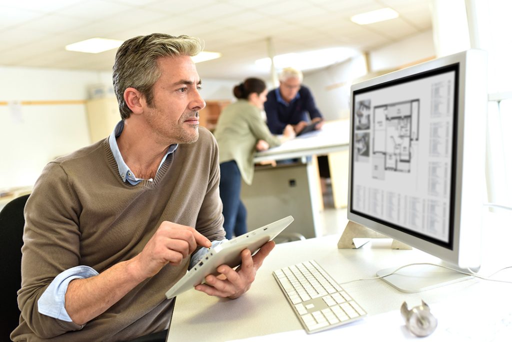 Engineer working in design office on desktop computer