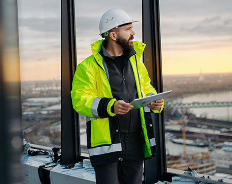 Engineer overseeing city construction project with blueprints in hand.