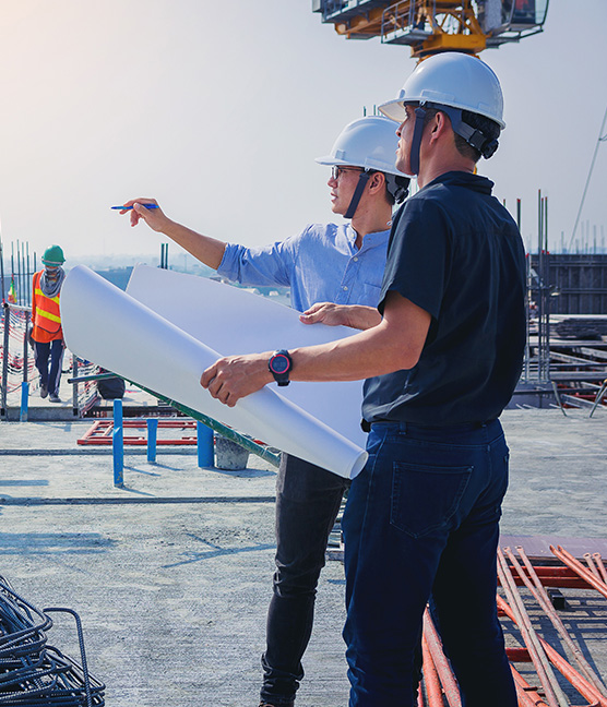 Structural engineer and architect working with blueprints discus