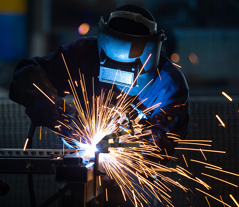 Workers wearing industrial uniforms and Welded Iron Mask at Stee